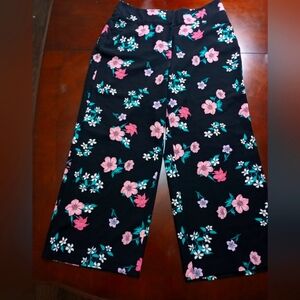 LANE BRYANT WIDE PANTS BLACK COLOR WITH PINK AND WHITE FLOWERS AND GREEN LEAVES.
